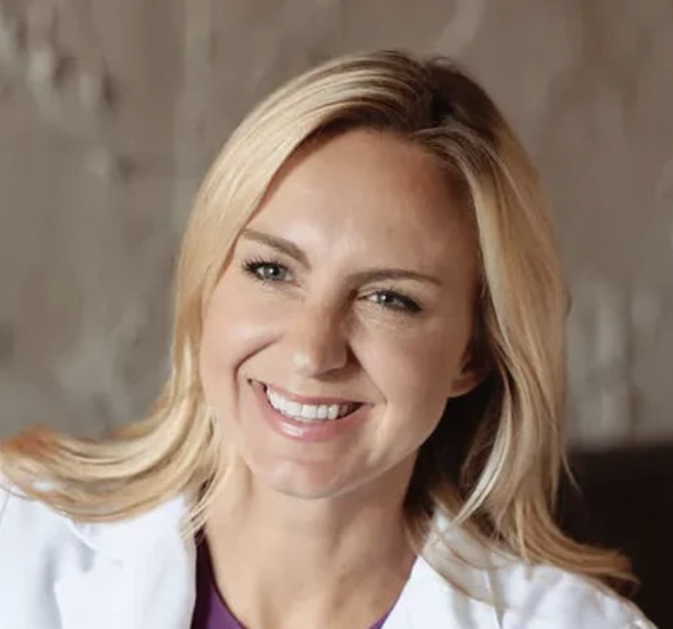 a blonde woman in a white lab coat