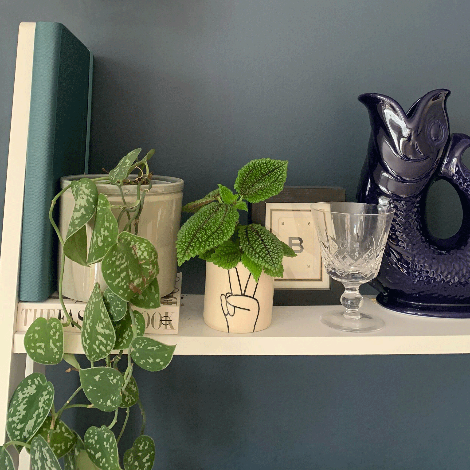 Green logitech pop up desk next to books