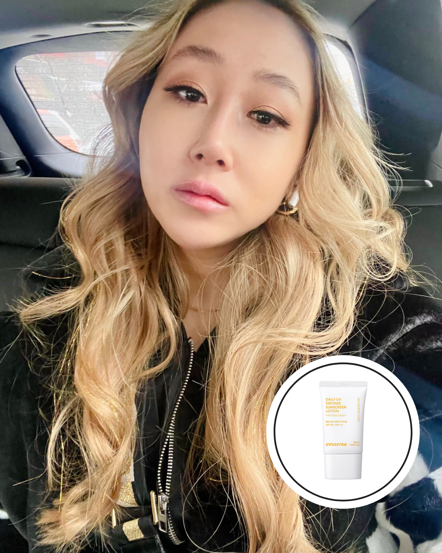 A woman with blonde curls and pink lipstick wearing a black leather jacket