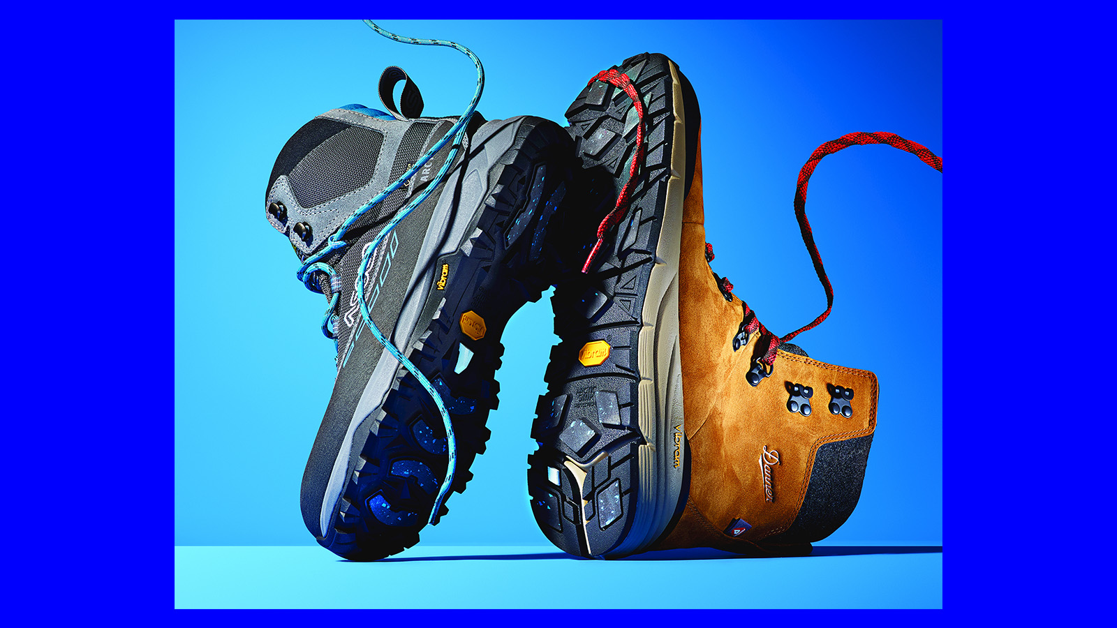 a pair of Vibram sole hiking boots in blue background