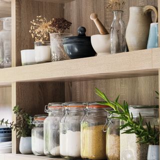 Shelves in the kitchen, storage jars and pottery, close up