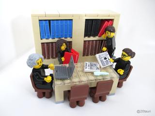 Lego figures reading newspapers