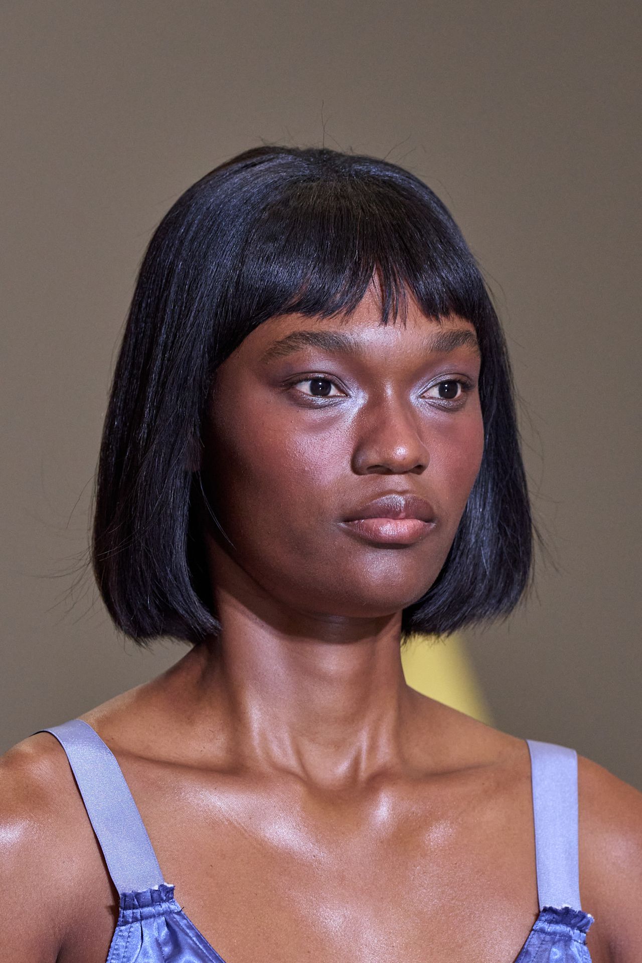Lip gloss lids at Sandy Liang on a model in a purple dress with. abob