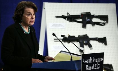 Sen. Dianne Feinstein speaks in front of a display of assault weapons during a news conference on Jan. 24.