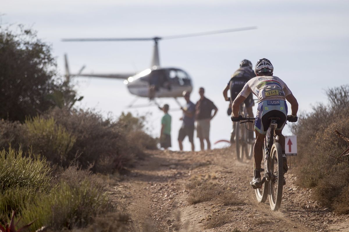 A helicopter hovers over riders on stage 4 of the 2015 Absa Cape Epic