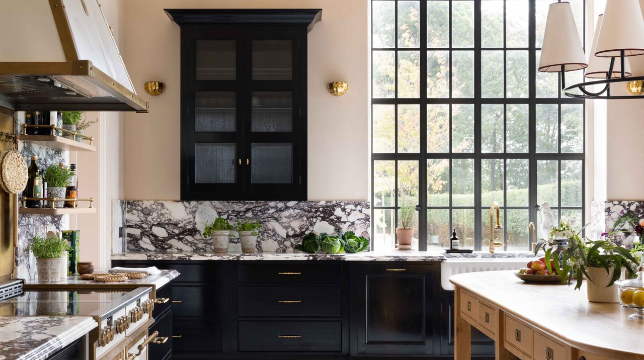 black kitchen with bold marble and brass finishes
