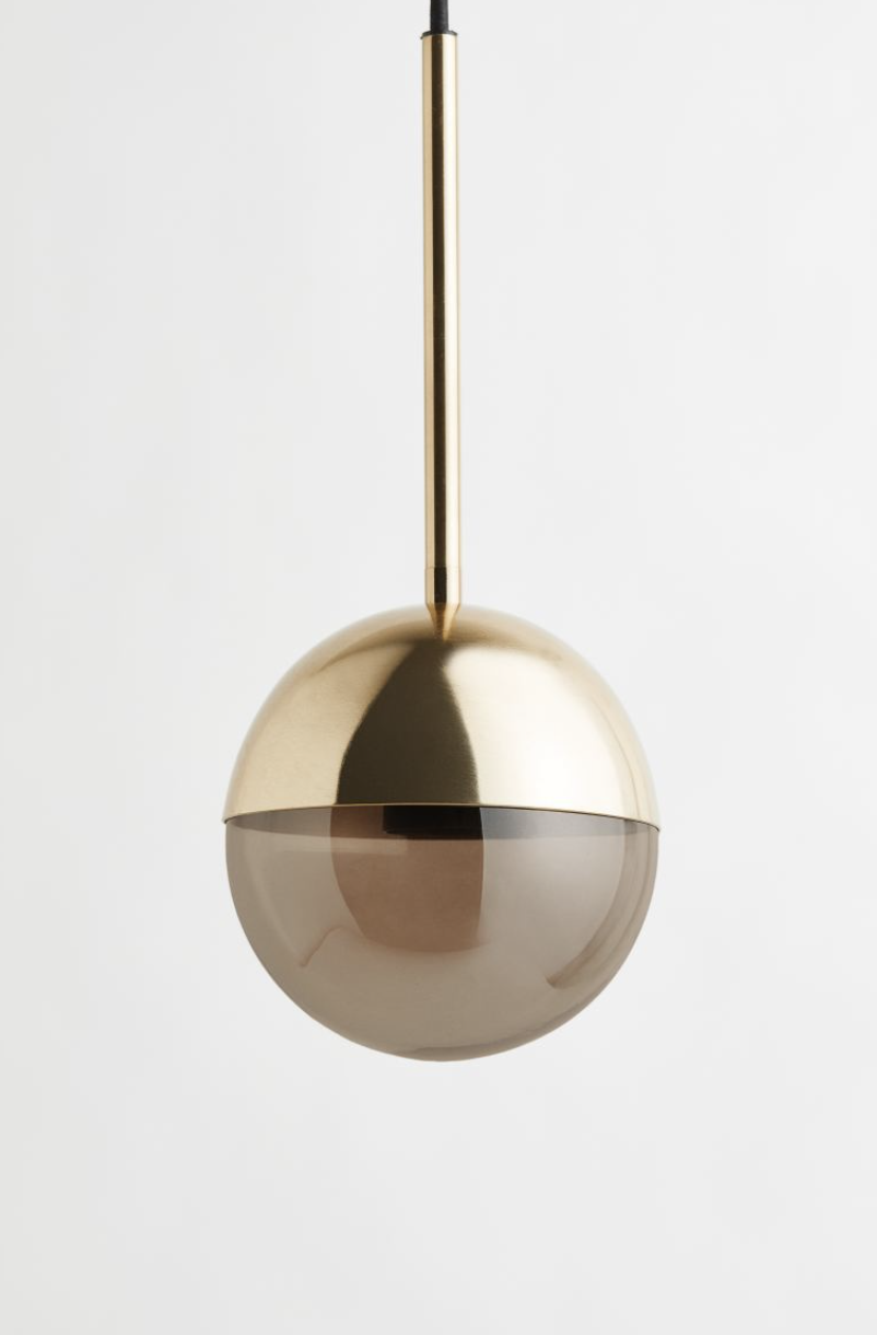 Glass orb pendant lamp with bronzed gold shade form H&M Home.
