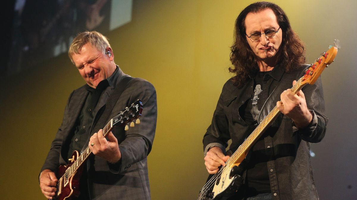 Alex Lifeson and Geddy Lee come together on stage. Rush plays the first of two nights in Toronto of their farewell tour, R40 LIVE Tour, that also celebrates the 40 years the band has been in existence. at Air Canada Centre
