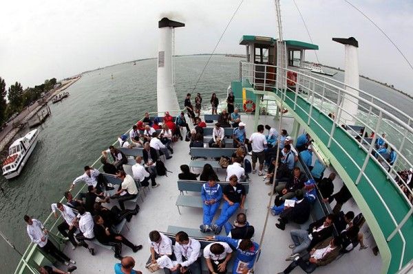 Riders take the boat to Venice's Lido.