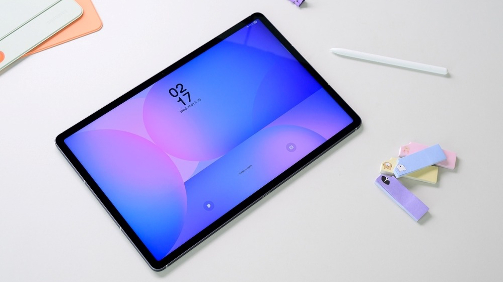 Lifestyle image of Galaxy Tab S10 FE Plus on table with S Pen next to it