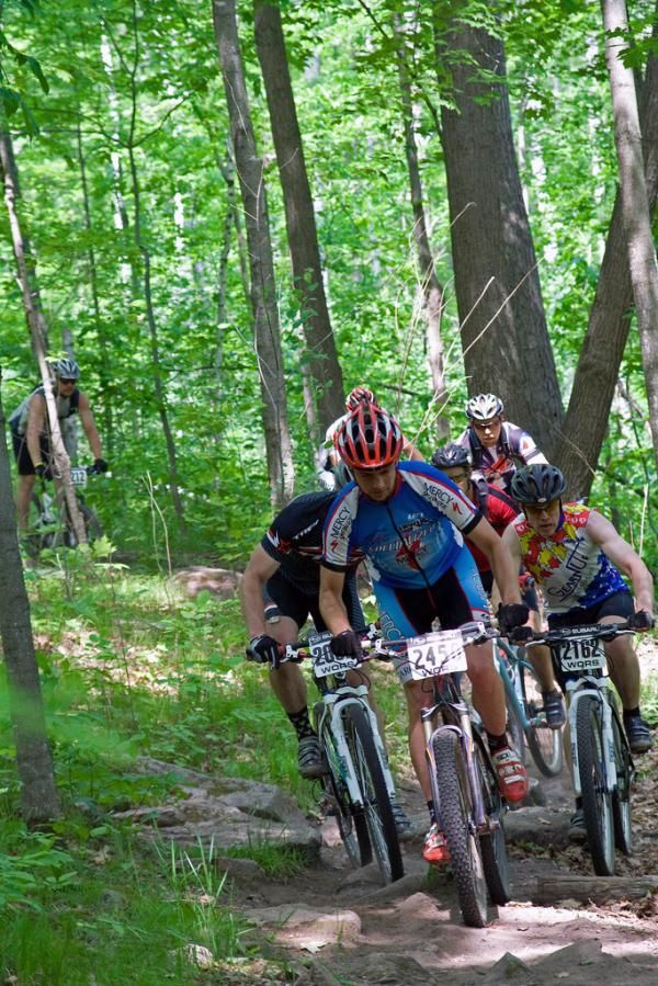 Cat 2 racers navigate a rock garden at the WORS Big Ring Classic at 9-Mile Forest