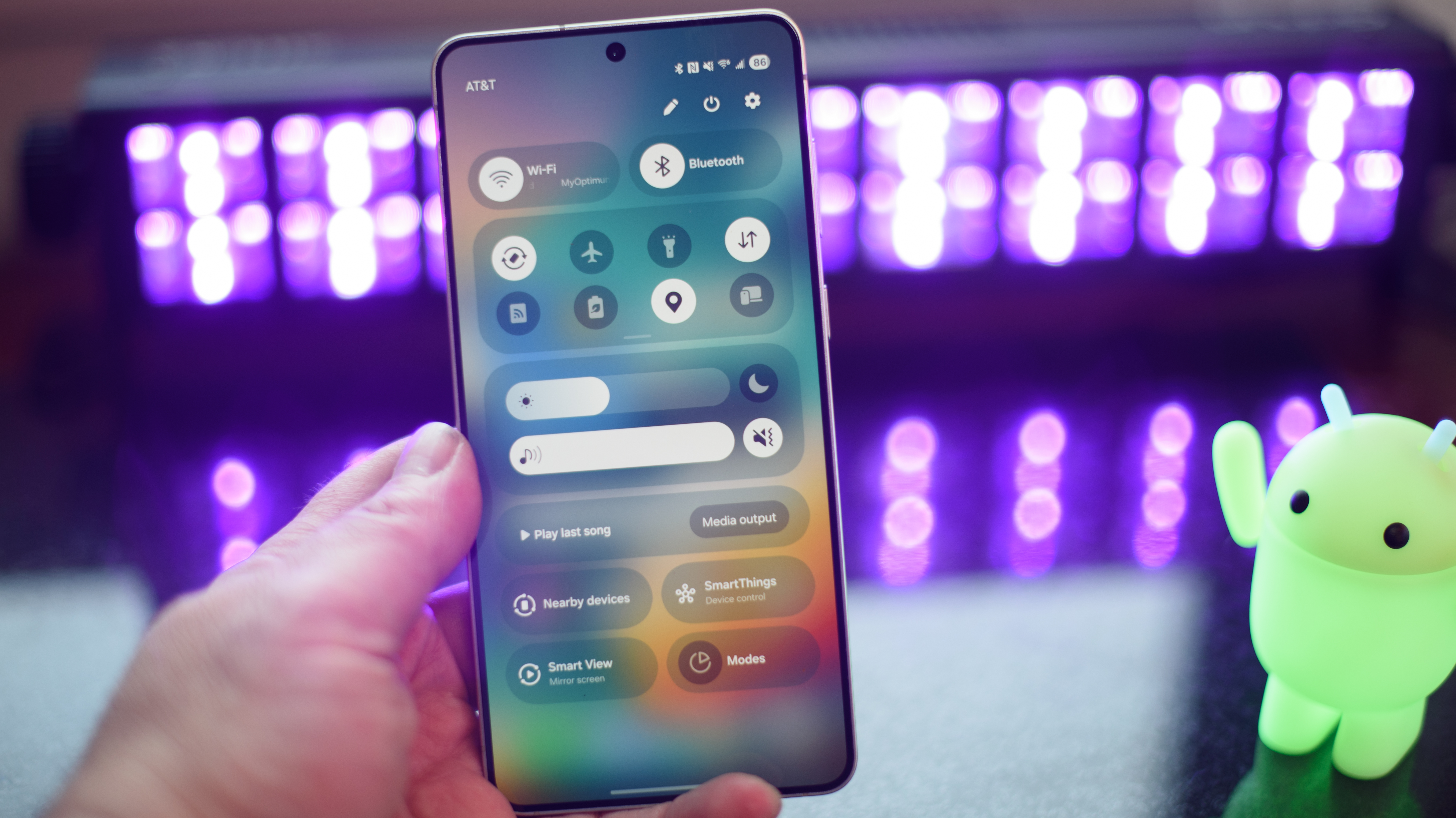 Samsung Galaxy S25 Edge showing settings and controls with black lights and an Android figuring blurred in the background