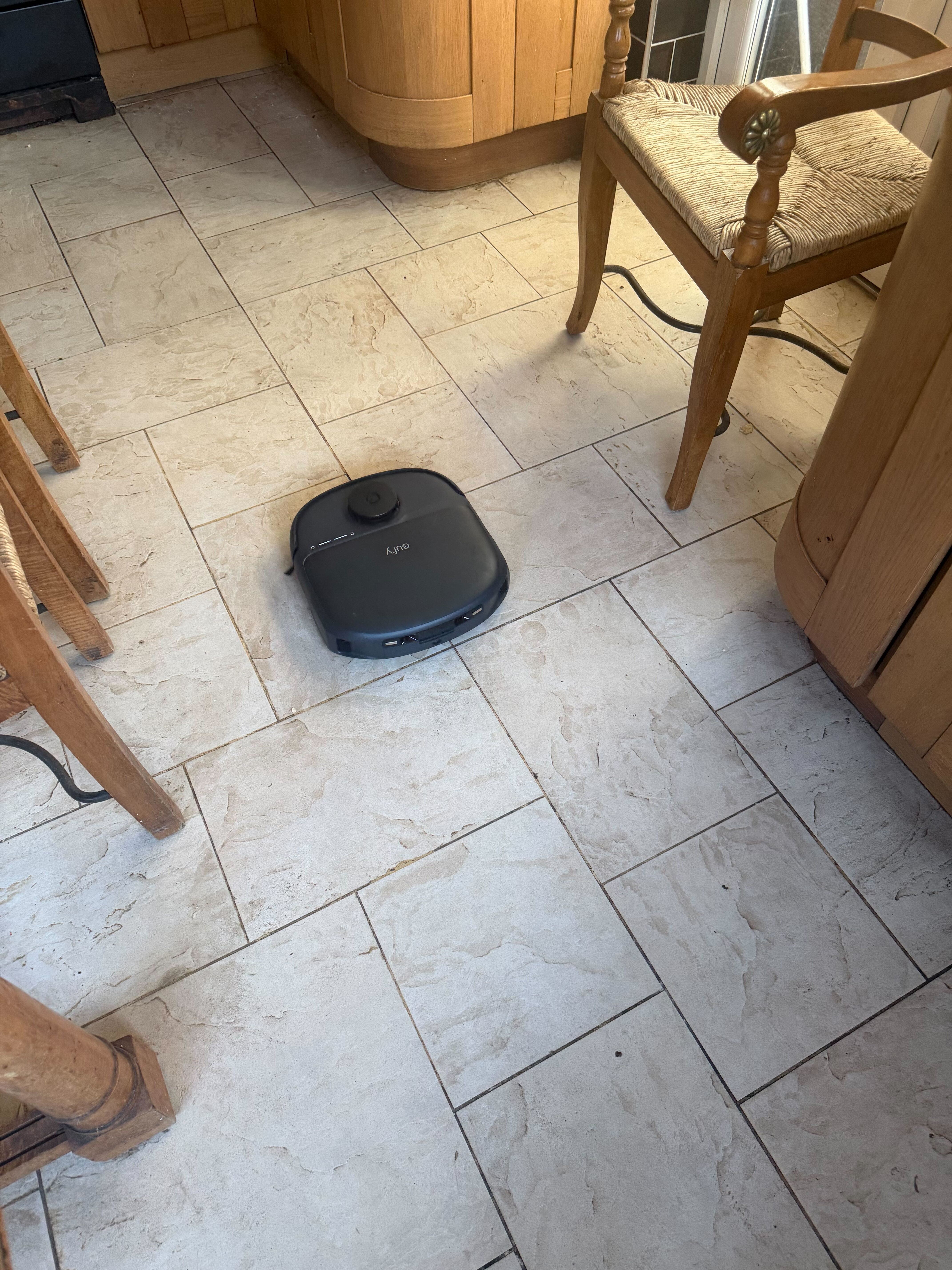 Italian stone flooring being cleaned by a robovac