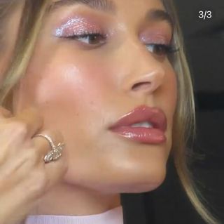 A photo of Hailey Bieber wearing rose gold glitter pigment on her eyes