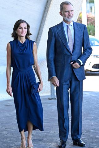 Queen Letizia of Spain wears a blue skirt and top alongside King Felipe VI of Spain as they arrive at an institutional act of recognition to professionals and volunteers who participated in the different fire extinguishing work in Tenerife at the Arafo Cultural and Recreation Center on October 24, 2023 in Santa Cruz de Tenerife, Spain.