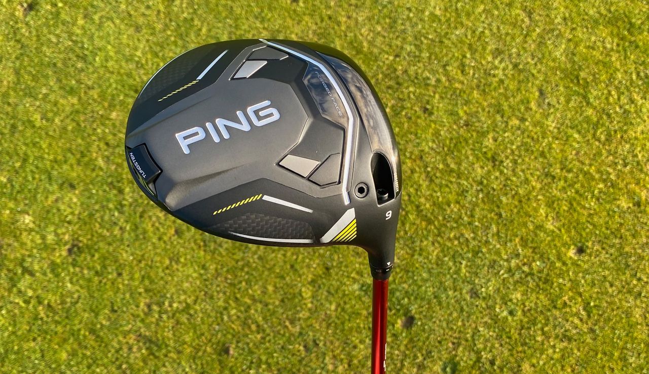 The sole of the Ping G430 Max 10K Driver on a green background