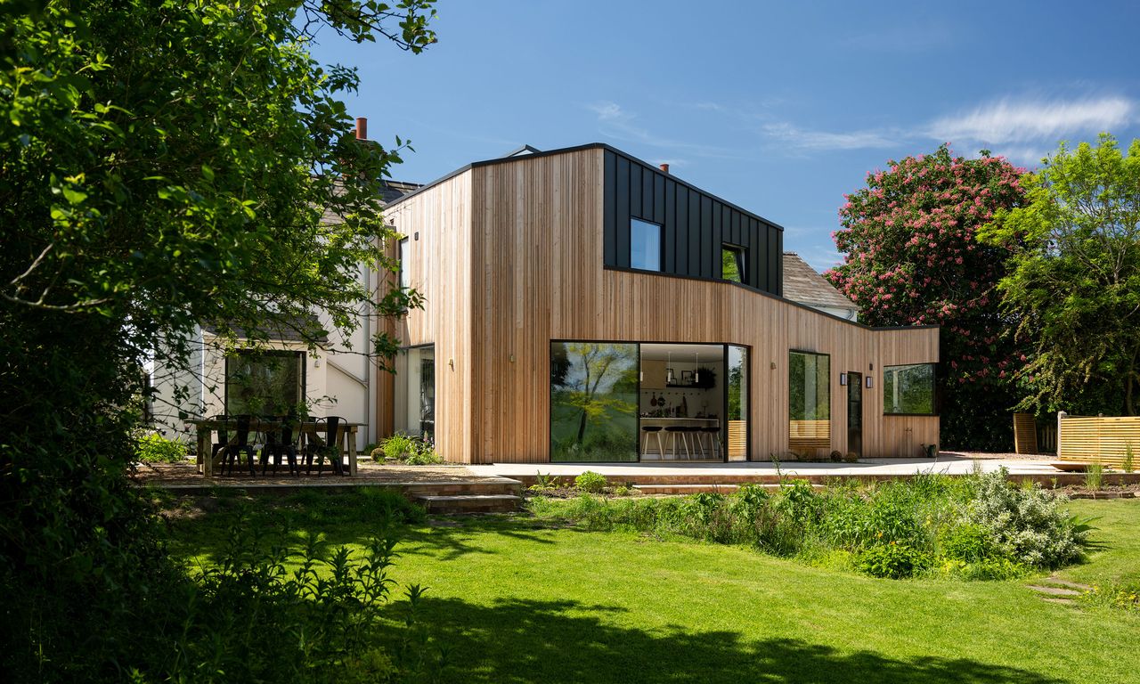 Exterior of Victorian cottage with rear extension featuring larch wooden cladding