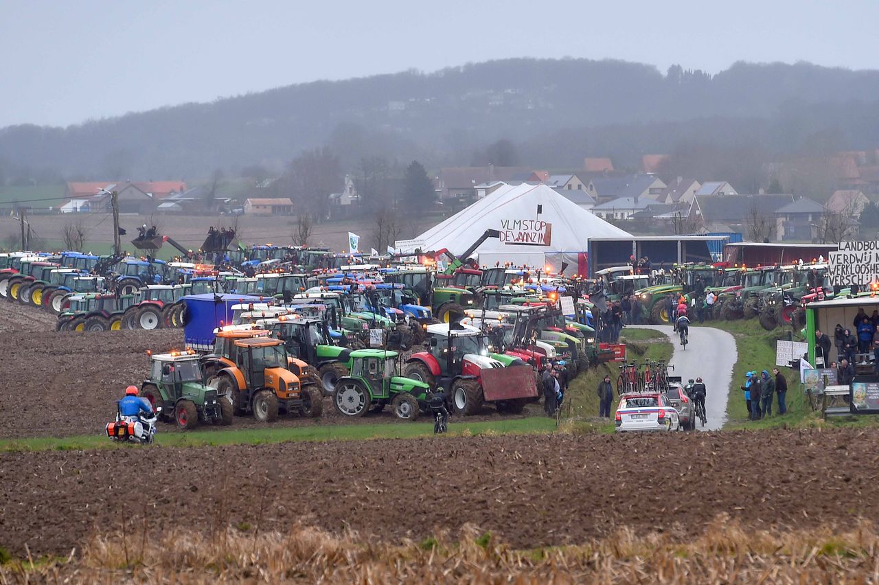 A protest of tractors flanks the road