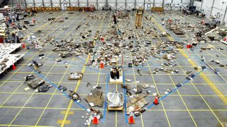 Columbia disaster debris strewn across the floor in a hangar
