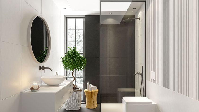 Contemporary cream bathroom with round mirror on wall and shower screen with black edge