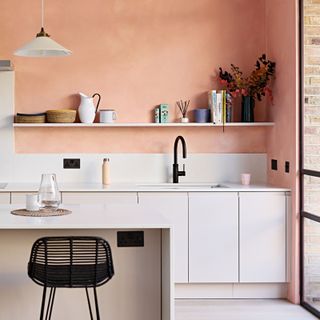 a kitchen with an orange limewash paint finish
