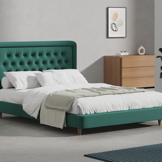 Simba mattress on green bed with white bedding and grey throw