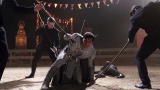 Oscar Isaac's Moon Knight being stabbed by black-suited bad guys