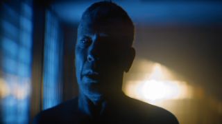 Mikael Persbrandt looks panicked while an explosion goes off outside in Foundation.