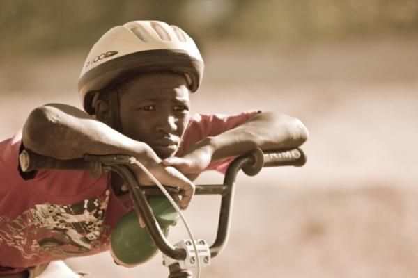 A young boy watches the action.