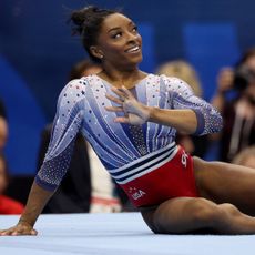 Simone Biles at the US Olympic Trials wearing a sparkly leotard in red white and blue