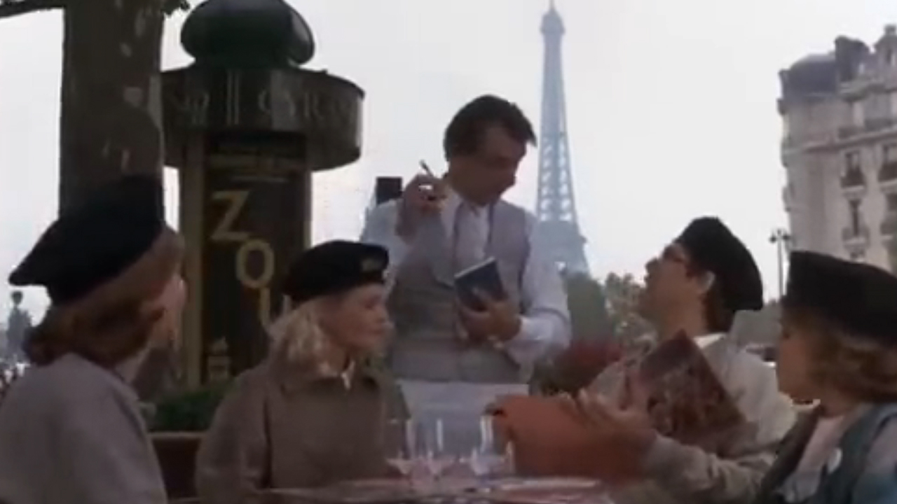 A waiter talking to the Griswalds with the Eiffel in the background