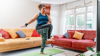 Woman competing a dance HIIT workout at home