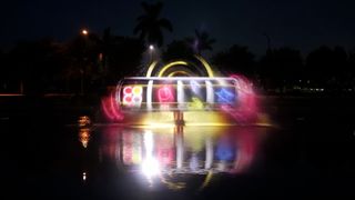 A 20,000-lumen projector displays images onto a 70-foot-by-30-foot water screen, giving the appearance of massive “floating holograms” to onlookers.