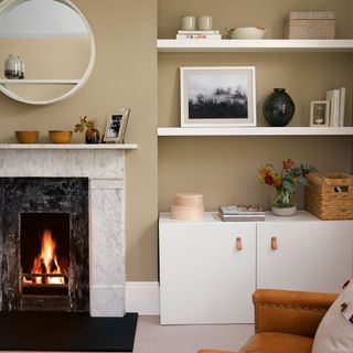 living room with fireplace and shelves on wall