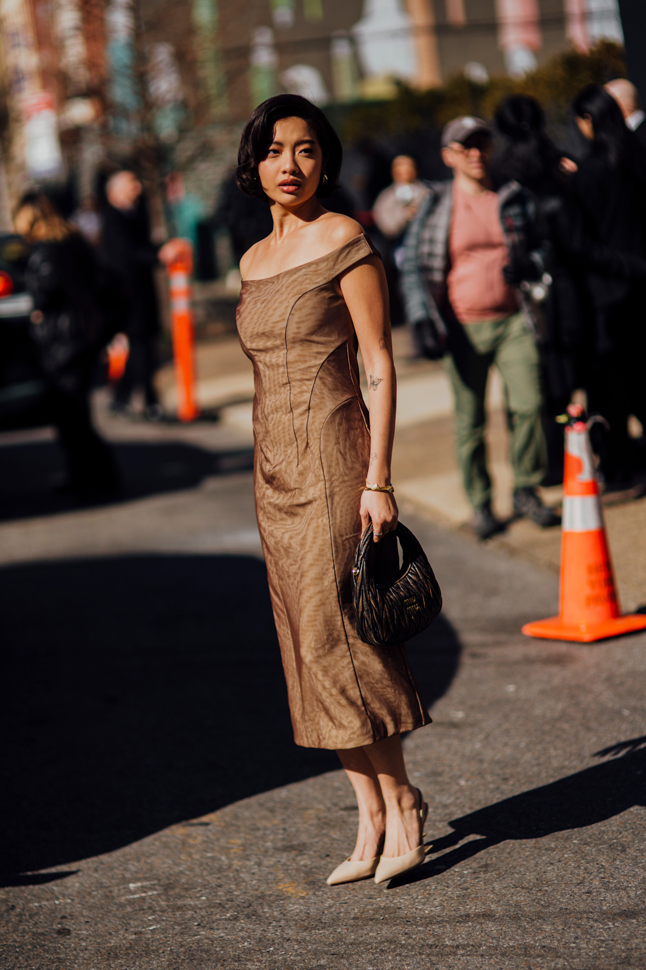 woman wearing fitted brown dress