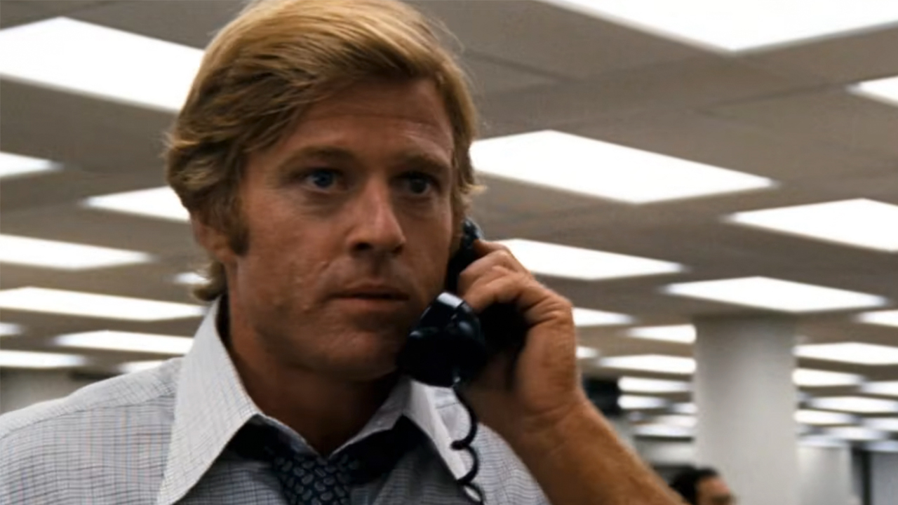 Robert Redford looking series while talking on the phone in All the President's Men.