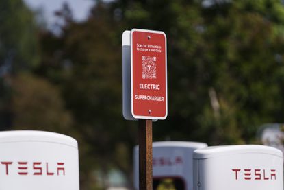 A Tesla charging point and corresponding sign