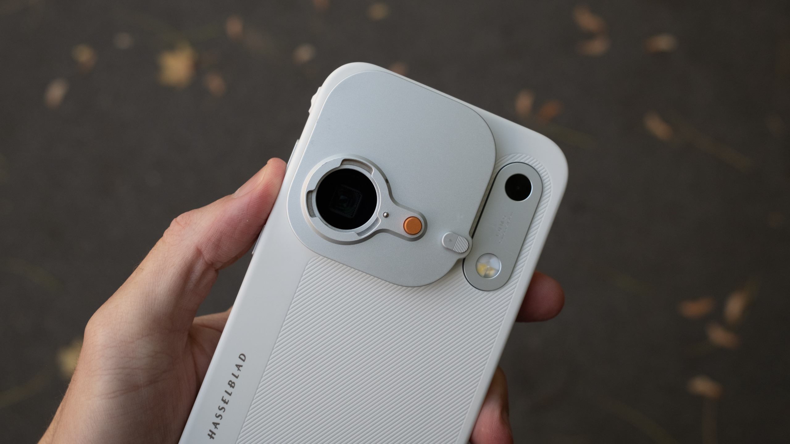 Close-up of the Oppo Find X10 Pro Max fitted with a camera accessory plate, exposing the mount around one of the rear lenses.