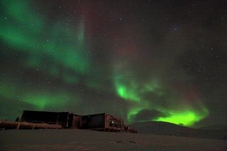 This shows an aurora appearing in the night sky at the Kjell Henriksen Observatory in Svalbard, Norway. Taken November 2010.
