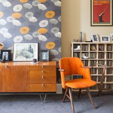 living room corner with retro floral wallpaper open shelves and sideboard cabinet