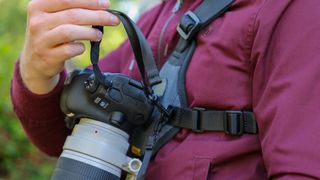 Cotton Carrier Skout G2 worn by a man in a burgandy jacket outdoors in a woods