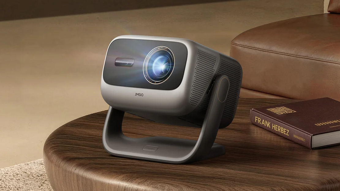 The JMGO N3 Ultimate on a coffee table in a home theater.