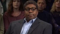 Kenan Thompson sits with a straight face during a sketch on SNL.