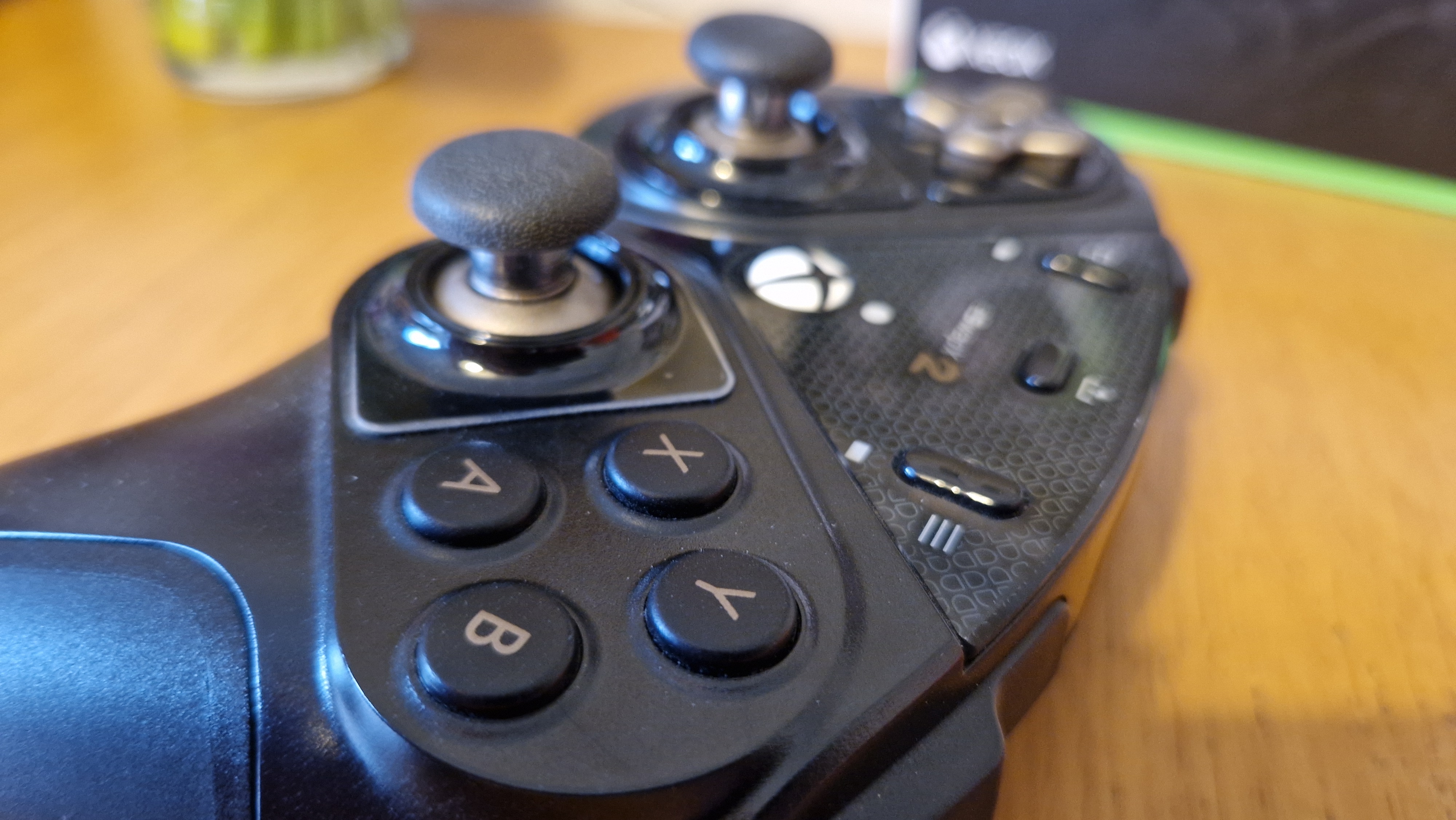 The Thrustmaster eSwap X2 controller on a wooden surface