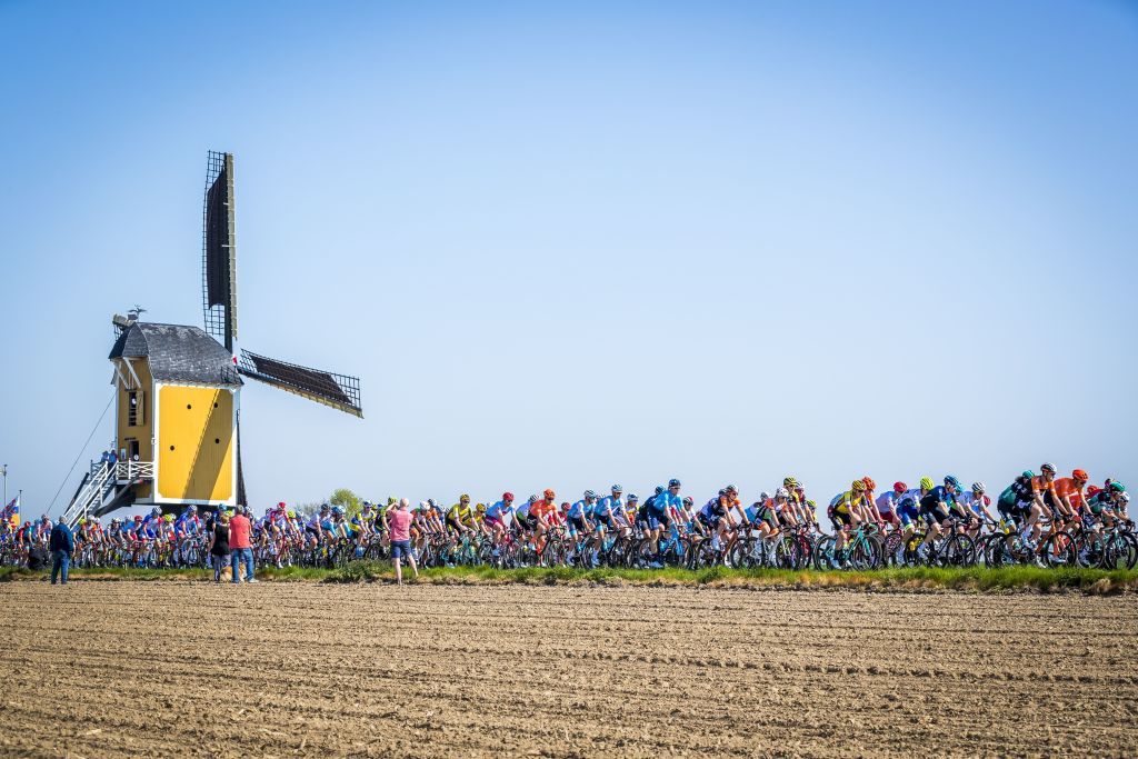 TOPSHOT The peleton rides past a windmill during the Amstel Gold Cycling Race in Maastricht Netherlands on April 21 2019 Photo by Marcel van Hoorn ANP AFP Netherlands OUT Photo credit should read MARCEL VAN HOORNAFP via Getty Images