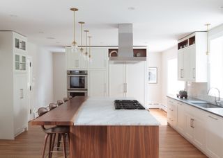 what's the best material for split-level kitchen islands?white kitchen with split-level kitchen island by Melinda Kelson O'Conner Design