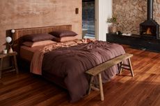 A bedroom with terracotta and caramel sheets