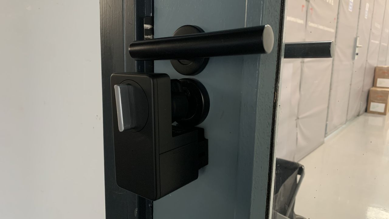 Opened Switchbot lock fitted on a door