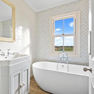 bathroom with white bathtub and white sink
