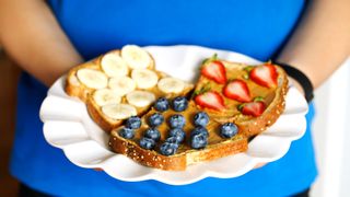 Nut butter spread onto bread with fruit